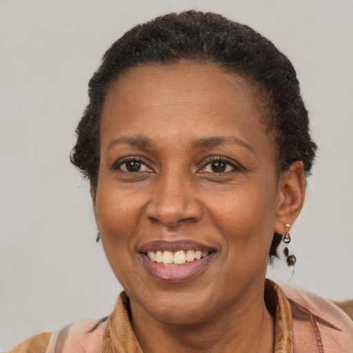 Joyful latino adult female with short  brown hair and brown eyes