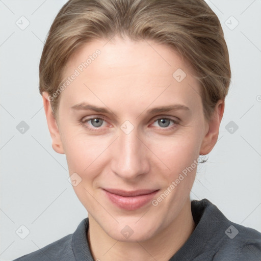 Joyful white young-adult female with short  brown hair and grey eyes