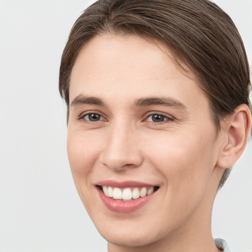 Joyful white young-adult female with short  brown hair and brown eyes