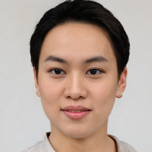 Joyful asian young-adult female with short  black hair and brown eyes