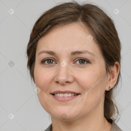 Joyful white adult female with medium  brown hair and grey eyes