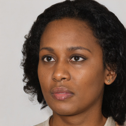 Neutral black young-adult female with medium  black hair and brown eyes