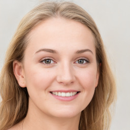 Joyful white young-adult female with long  brown hair and blue eyes