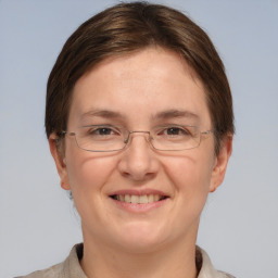 Joyful white adult female with short  brown hair and grey eyes