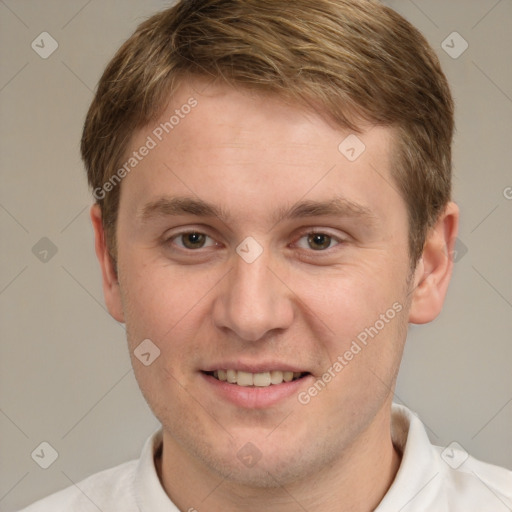 Joyful white young-adult male with short  brown hair and grey eyes