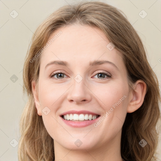 Joyful white young-adult female with long  brown hair and green eyes