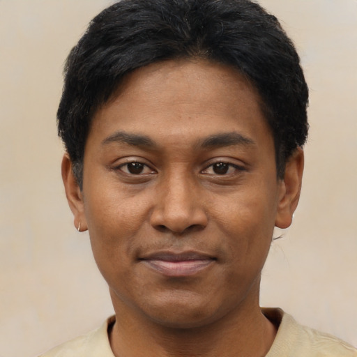 Joyful latino young-adult male with short  black hair and brown eyes