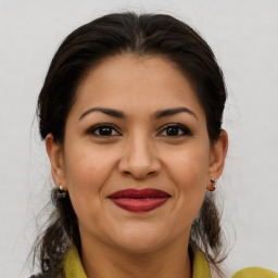 Joyful latino young-adult female with medium  brown hair and brown eyes