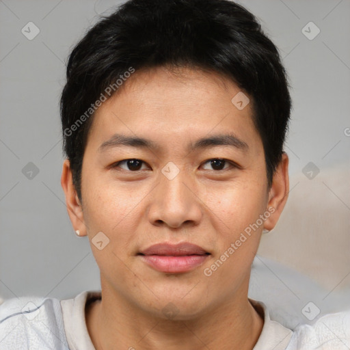 Joyful asian young-adult male with short  brown hair and brown eyes