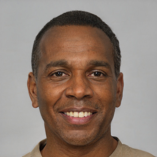 Joyful black adult male with short  black hair and brown eyes