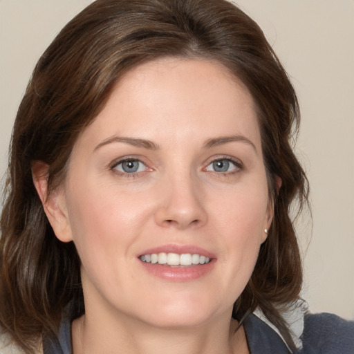 Joyful white young-adult female with medium  brown hair and blue eyes