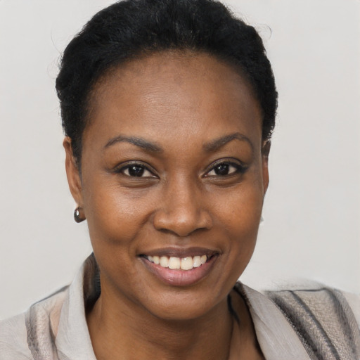 Joyful black young-adult female with short  brown hair and brown eyes