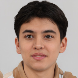 Joyful asian young-adult male with short  brown hair and brown eyes