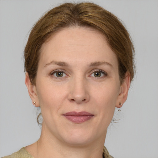 Joyful white adult female with medium  brown hair and grey eyes