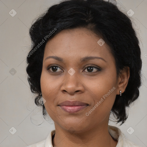 Joyful black adult female with medium  brown hair and brown eyes