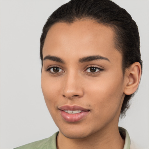 Joyful latino young-adult female with short  brown hair and brown eyes