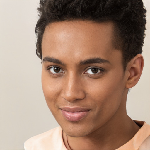 Joyful black young-adult male with short  brown hair and brown eyes