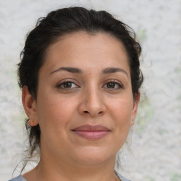 Joyful white adult female with medium  brown hair and brown eyes