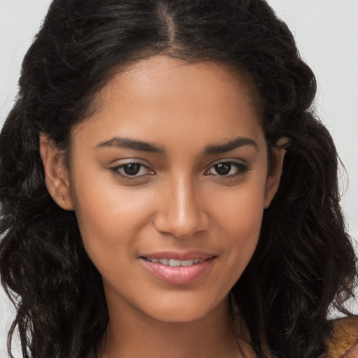 Joyful latino young-adult female with long  brown hair and brown eyes