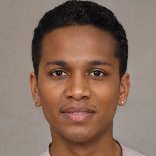 Joyful black young-adult male with short  black hair and brown eyes