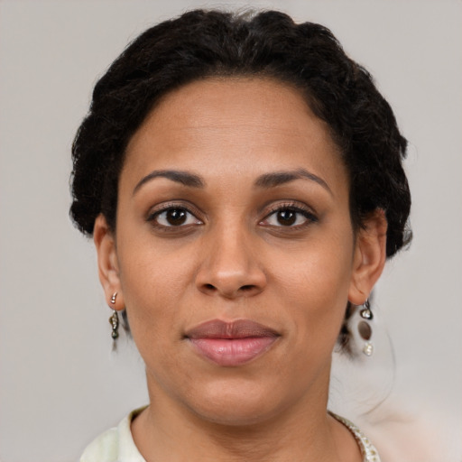 Joyful black young-adult female with short  brown hair and brown eyes
