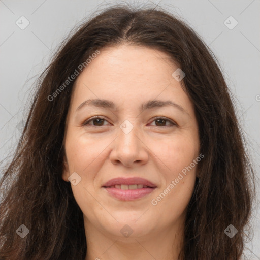 Joyful white adult female with long  brown hair and brown eyes