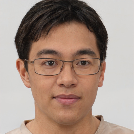 Joyful asian adult male with short  brown hair and brown eyes