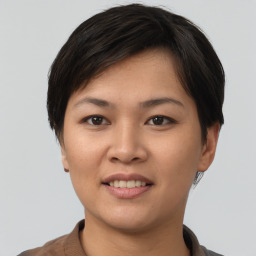 Joyful asian young-adult female with short  brown hair and brown eyes