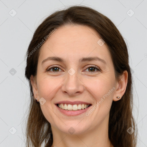 Joyful white young-adult female with long  brown hair and grey eyes