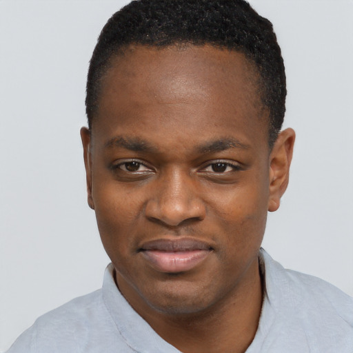 Joyful black young-adult male with short  black hair and brown eyes