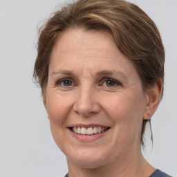 Joyful white adult female with medium  brown hair and brown eyes