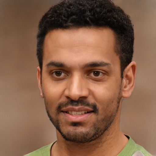 Joyful latino young-adult male with short  black hair and brown eyes