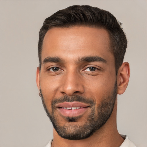 Joyful white young-adult male with short  black hair and brown eyes