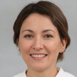 Joyful white adult female with medium  brown hair and brown eyes