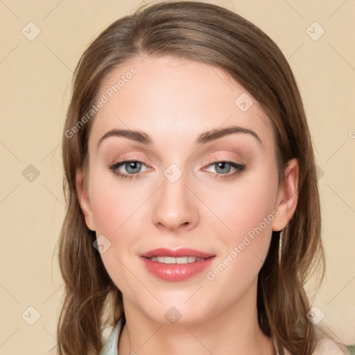 Joyful white young-adult female with long  brown hair and green eyes