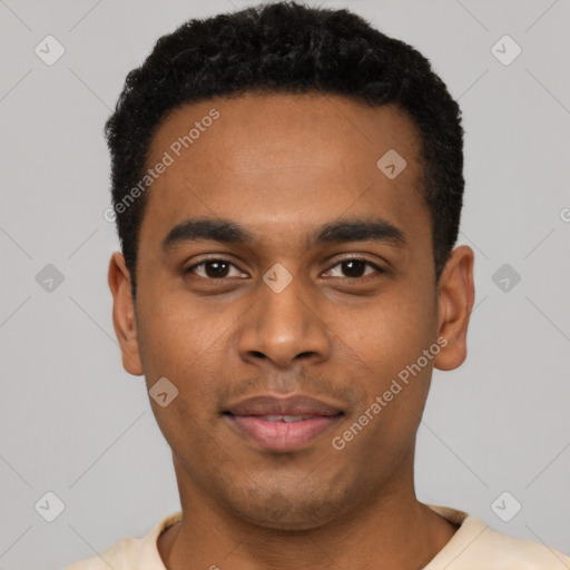 Joyful black young-adult male with short  black hair and brown eyes