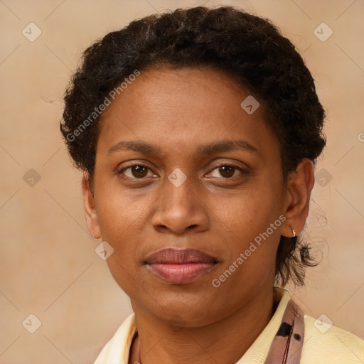 Joyful black adult female with short  brown hair and brown eyes