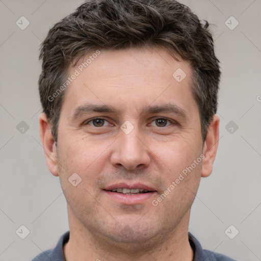 Joyful white adult male with short  brown hair and brown eyes