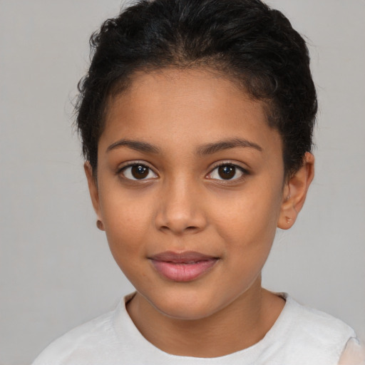 Joyful latino child female with short  brown hair and brown eyes