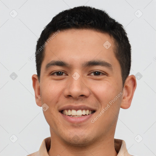 Joyful latino young-adult male with short  brown hair and brown eyes