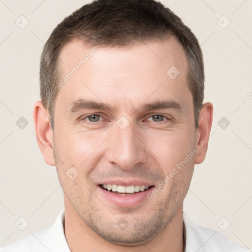 Joyful white young-adult male with short  brown hair and brown eyes