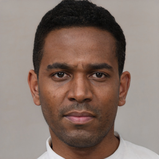 Neutral black young-adult male with short  black hair and brown eyes