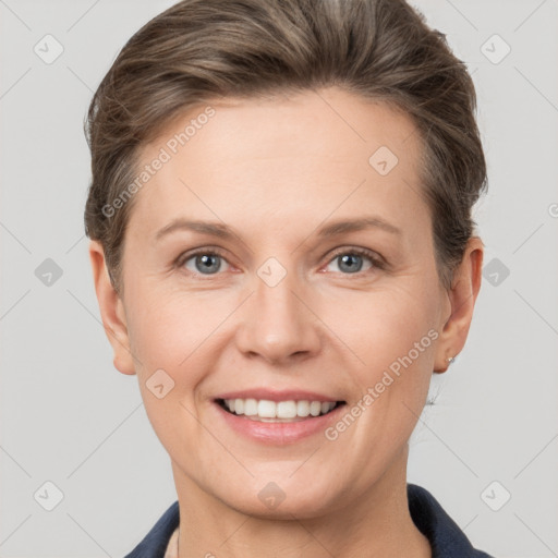 Joyful white adult female with short  brown hair and grey eyes