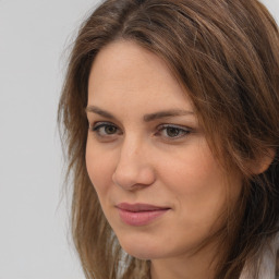 Joyful white adult female with long  brown hair and brown eyes