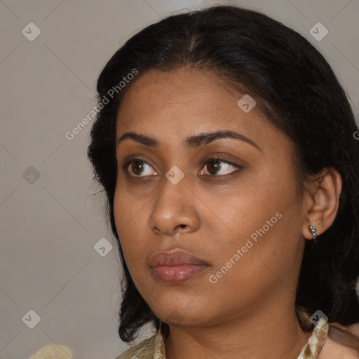 Neutral black young-adult female with medium  brown hair and brown eyes