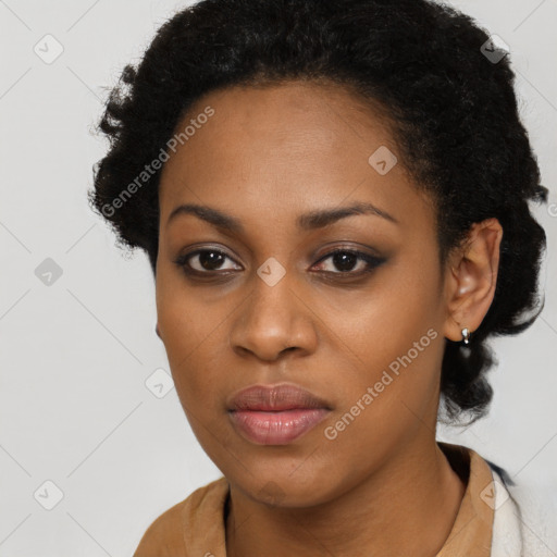 Joyful black young-adult female with short  black hair and brown eyes