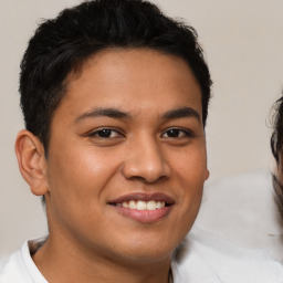 Joyful latino young-adult male with short  brown hair and brown eyes