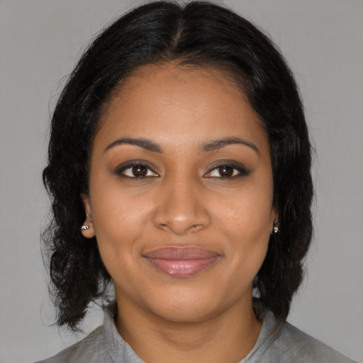 Joyful black young-adult female with medium  black hair and brown eyes