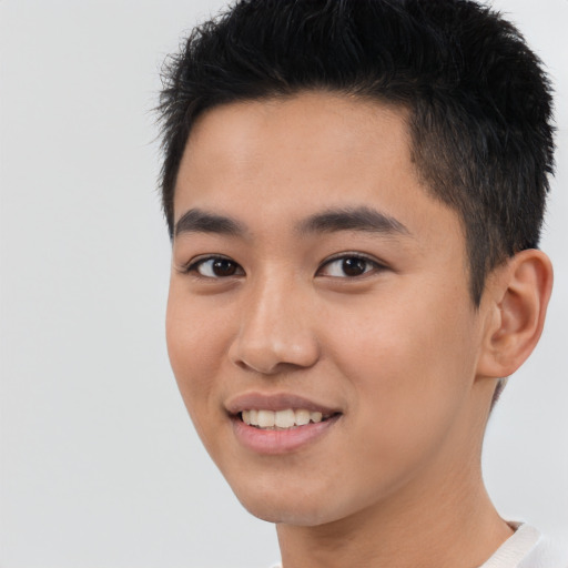 Joyful asian young-adult male with short  black hair and brown eyes