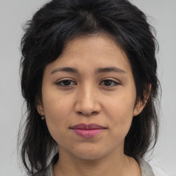 Joyful asian young-adult female with medium  brown hair and brown eyes